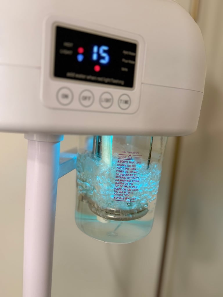 White water cooler dispenser with digital display showing 15 degrees and a transparent water bottle attached below